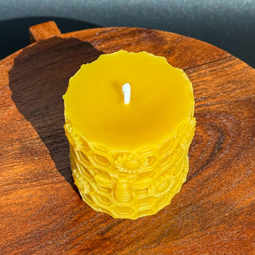Beeswax pillar, honeycomb and bees