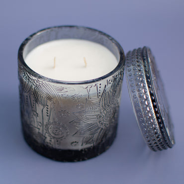 The Ubud fragrance free candle showing double wick, embossed black glass vessel