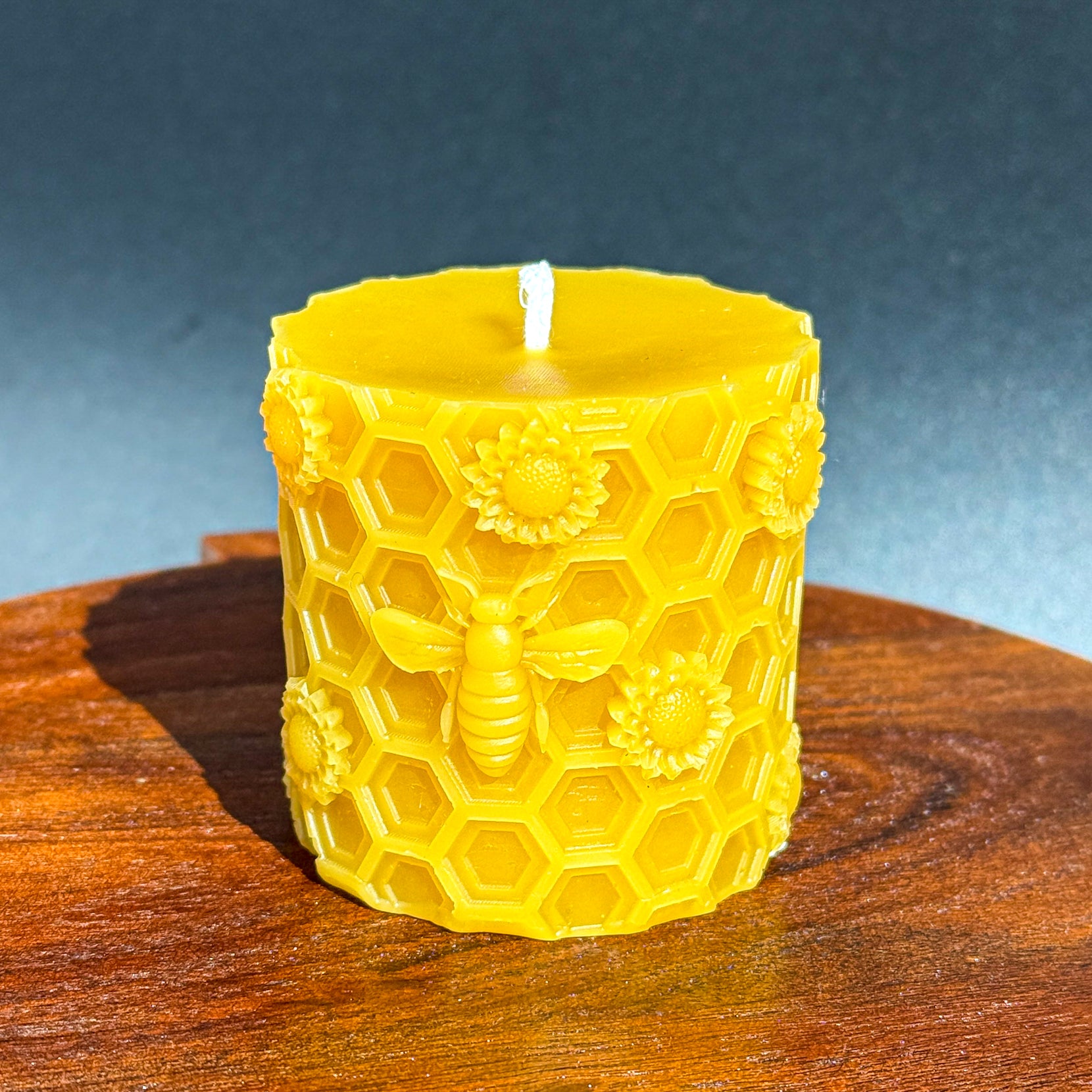 Beeswax pillar, honeycomb and bees
