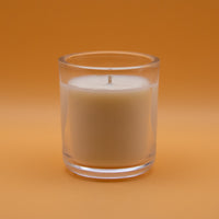 The Unscented Candle Company votive candle on peach background